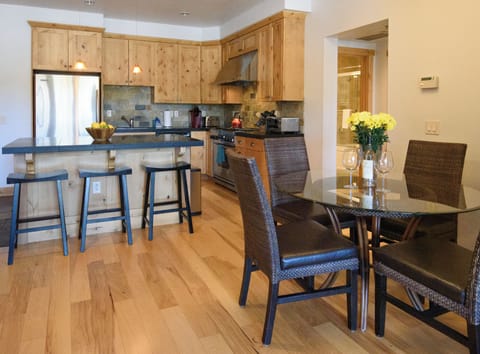 Warm wood kitchen with breakfast bar and stylish dining space