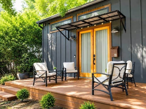 Outdoor deck with comfortable seating—perfect for morning coffee or relaxing under the shade of beautiful oak trees.