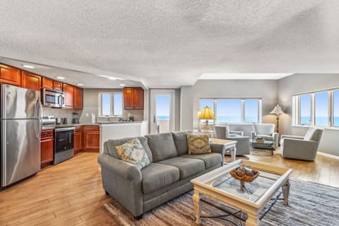 Spacious Living Room Featuring Panoramic Oceanfront Views, Seating Area with Plush Swivel Chairs, and a Flat Screen Smart TV (Sleeper Sofa)