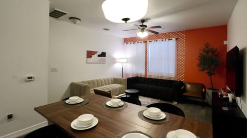 Cozy modern living room with dining space, sectional seating, and TV