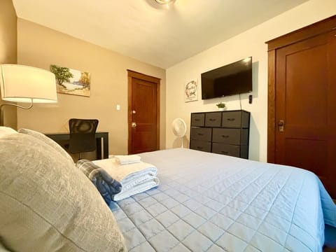 Indulge in a restful escape within this cozily designed bedroom, boasting a pleasant queen bed, a dedicated workspace with a desk, a stylish dresser, and a generous closet. Experience the perfect blend of comfort and sophistication