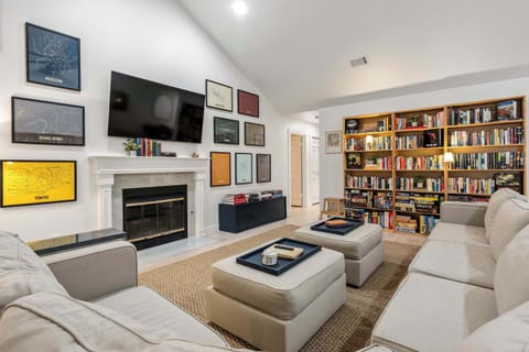 Relax beneath soaring vaulted ceilings with a 65" Smart TV and explore a thoughtfully curated library of over 2,000 books featuring fiction, travel, history, architecture, and beautiful coffee table books.
