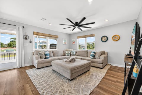 Unwind in your bright, airy living space with plush sectional seating and coastal charm—perfect for relaxing after a day at the beach.