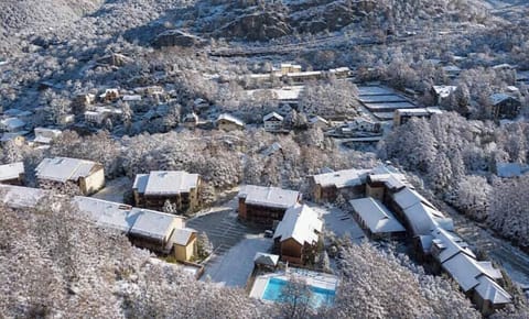 Snow settles over the residence in winter, with dog sledding and snowshoeing nearby.