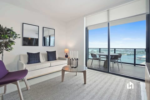 Relax in style with city views! Cozy living area and balcony access.