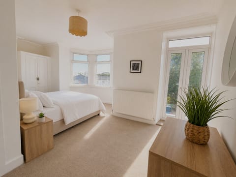 Bright double bedroom with a comfortable bed, built-in wardrobe and peaceful views.