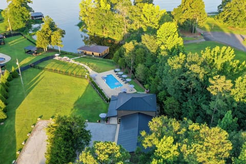 Private lakeside retreat with pool, huge lawn, and peaceful wooded setting