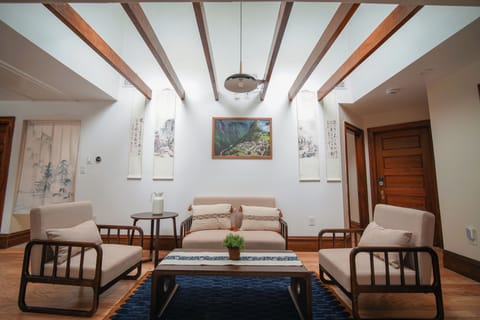Cozy living room with real wood furnitures. Picture hanging in the middle is from a trip in Machu Picchu.