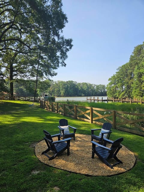 Fenced backyard, tree shaded sitting area with water views