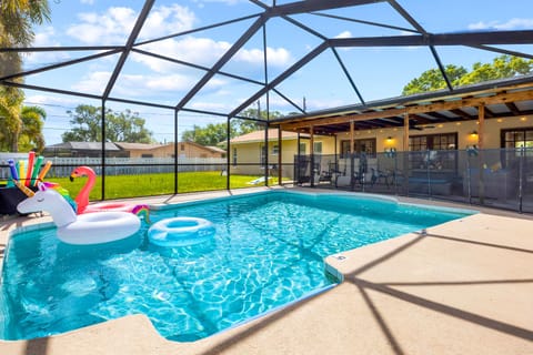 Screened saltwater pool with fun floats — perfect for cooling off, relaxing, and enjoying sunny Clearwater days.