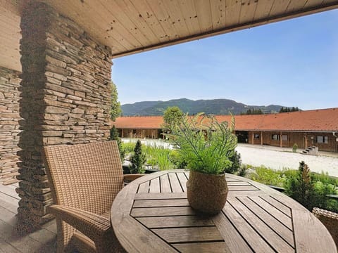Wood, Shade, Brick, Stone Wall, Wood Stain, Flagstone, Natural Material, Design, Porch, Chair