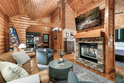 Main living room with 55'' ROKU TV, fireplace and pull out sofa bed with memory foam mattress.