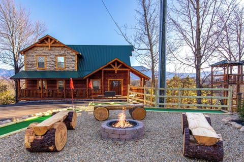 Rustic log cabin with fire pit, porch, and fun mini-golf area