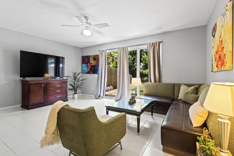Bright & airy living room with comfortable couches and smart TV