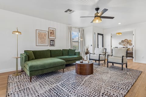 Ample seating, flatscreen TV, and open-concept living space.