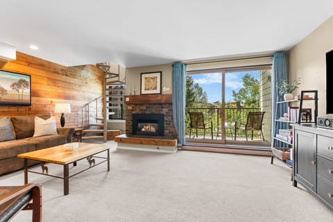 Sink into the plush sofa by your crackling fireplace, then step out onto your private balcony to breathe in the fresh mountain air and take in lush treetop views.