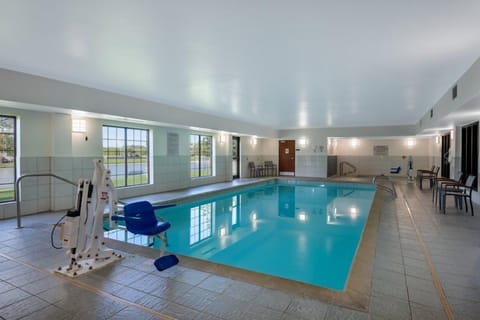 Indoor swimming pool with accessible seating.