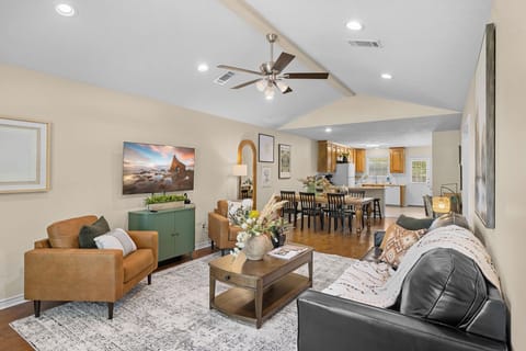 Bright open living space with vaulted ceilings, dining area, and full kitchen