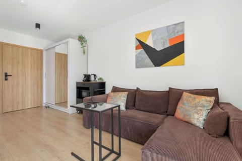 Relax in the stylish living room with a comfortable sofa and modern decor.