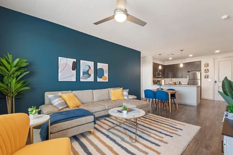 Stylish living room with elevated ceilings, a smart TV, comfortable seating, board games, and a dedicated dining area for evening entertainment.