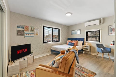 This stylishly furnished living space offers a comfortable sofa, a flat-screen TV with Netflix for entertainment, and a cozy bed for a restful night`s sleep.