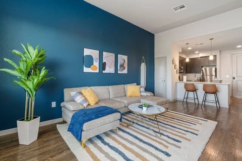 Stylish living room with elevated ceilings, a smart TV, comfortable seating, and board games for your entertainment.