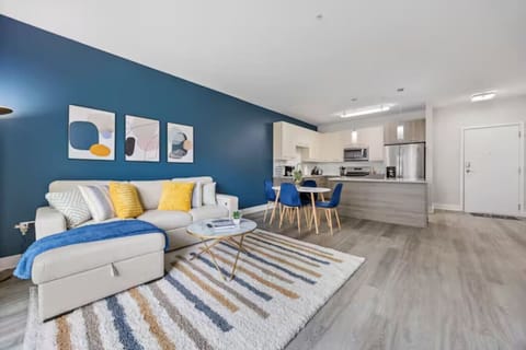Stylish living room with a smart TV, comfortable seating, and a dedicated dining area for evening entertainment.