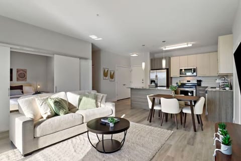 Stylish living room with a smart TV, comfortable seating, and a dedicated dining area for evening entertainment.