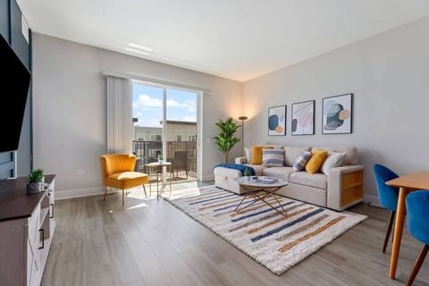 Stylish living room with a smart TV, comfortable seating, and a dedicated dining area for evening entertainment.