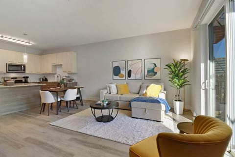 Stylish living room with a smart TV, comfortable seating, and a dedicated dining area for evening entertainment.