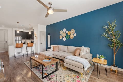 Enjoy this stylish living room featuring elevated ceilings, a smart TV for movie nights, comfortable seating, and board games for evening entertainment.