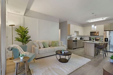 Stylish living room with a smart TV, comfortable seating, and a dedicated dining area for evening entertainment.