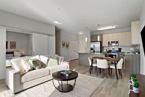 Stylish living room with a smart TV, comfortable seating, and a dedicated dining area for evening entertainment.