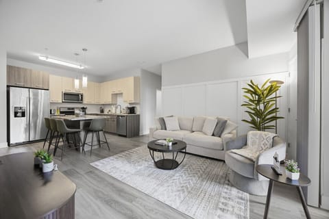 Stylish living room with a smart TV, comfortable seating, and a dedicated dining area for evening entertainment.