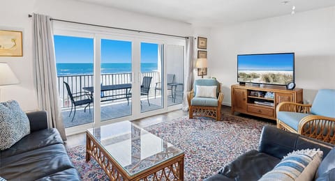 Relax in your bright oceanfront living room where panoramic sea views stretch endlessly beyond your private balcony. The perfect spot to unwind.