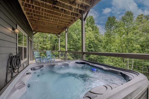 Blue Smoke Soak offers a private hot tub experience surrounded by the wooded mountain setting.