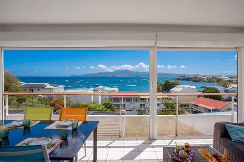 Terrace of Ti'Bato Apartment featuring panoramic views over Fort-de-France Bay and the Caribbean Sea.