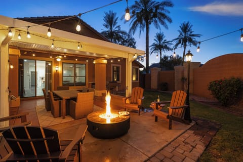 Inviting backyard patio with fire pit, string lights, and outdoor dining