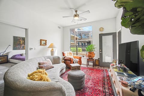 Bright living room with soaring ceilings and cozy designer touches.