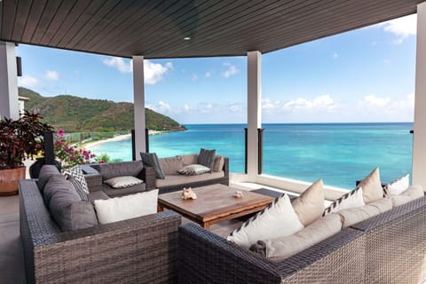 Lounge together on the terrace with sweeping turquoise views.