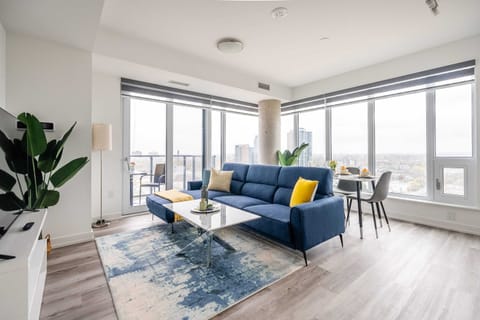 Bright Living Room With Floor-To-Ceiling Windows And A Comfortable Sofa Bed