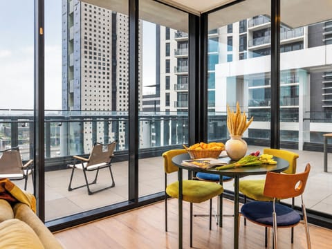 Bright corner dining space with wraparound balcony and city views