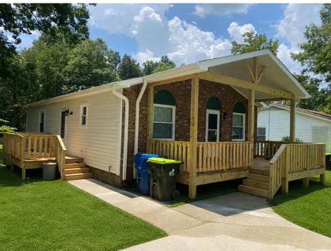 Side of house w/ side deck and 2 car driveway