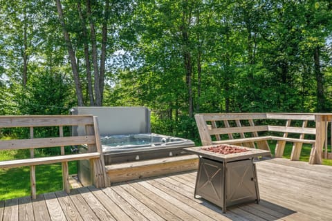 Unwind in the private 6-person hot tub right off the deck after exploring Acadia National Park. Relax around the propane fire table with built-in wrap-around bench seating, nestled in a quiet, rural Maine forest setting.
