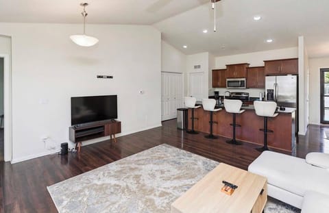 Bright open-concept living room and kitchen with island seating for 4