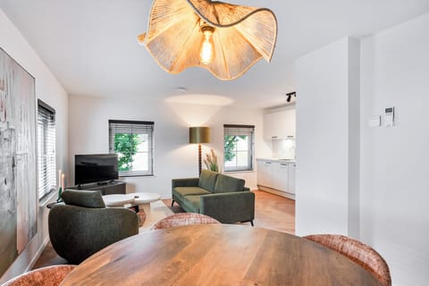 Bright 70m² apartment with a cozy living room, dining area, Smart TV, fast WiFi, and air conditioning. Perfect for up to 3 guests in the heart of the village center.