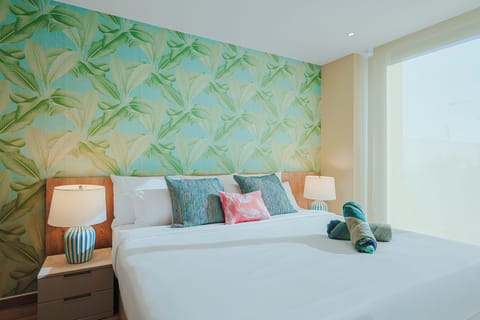 Unwind in your bright, tropical-inspired bedroom where fresh coastal colors and crisp linens invite restful nights. The cheerful palm wallpaper and thoughtful touches welcome you home after days of adventure.