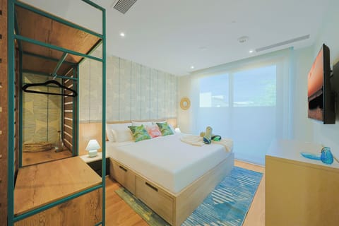 Sink into your cozy bed under soft lighting, with a private bathroom and wardrobe just steps away and calming views filling the bright, airy space.