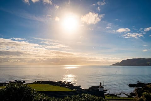 Sunlight glitters over the bay right from your coastal doorstep