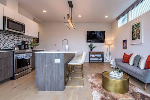 Cute and funky modern living space with full kitchen, easily seat 4 at the island for lunch or dinner. Two comfortable couches to sit on while you play games or watch TV!